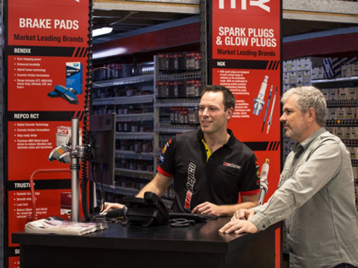 Repco employee assisting a customer.