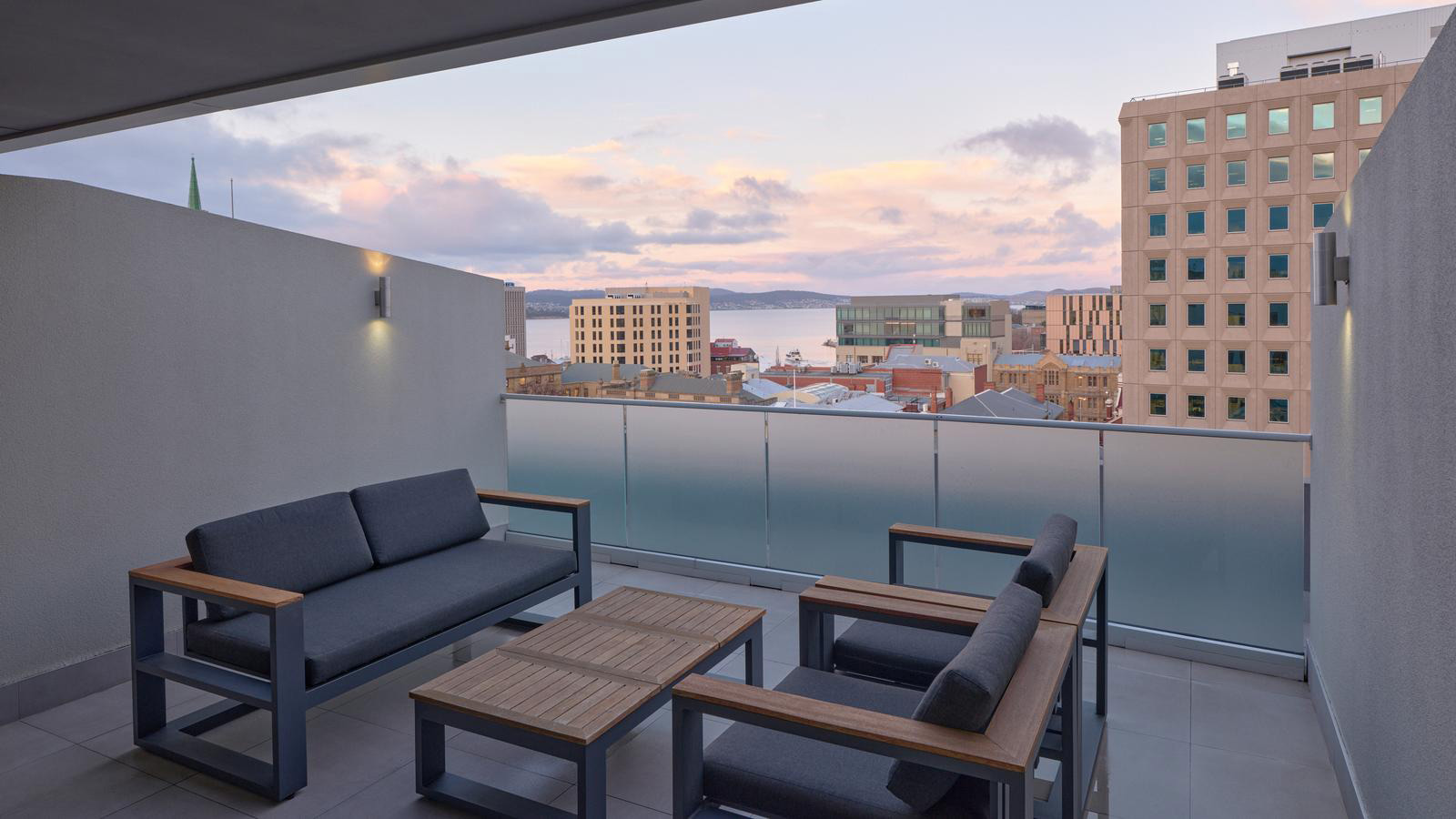 Outdoor furniture on balcony of deluxe apartment with harbour views at RACV Hobart Resort.