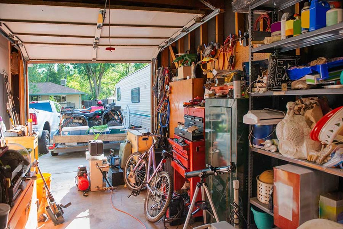 Garage with open door and expensive contents