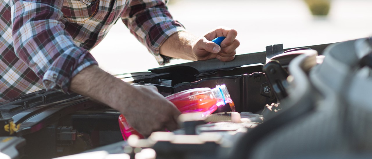 car-coolant-getty-1310974846-1400x600.jpg Man putting coolant in car