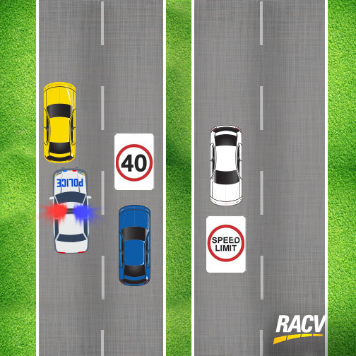 Cars passing an emergency vehicle on a divided road.