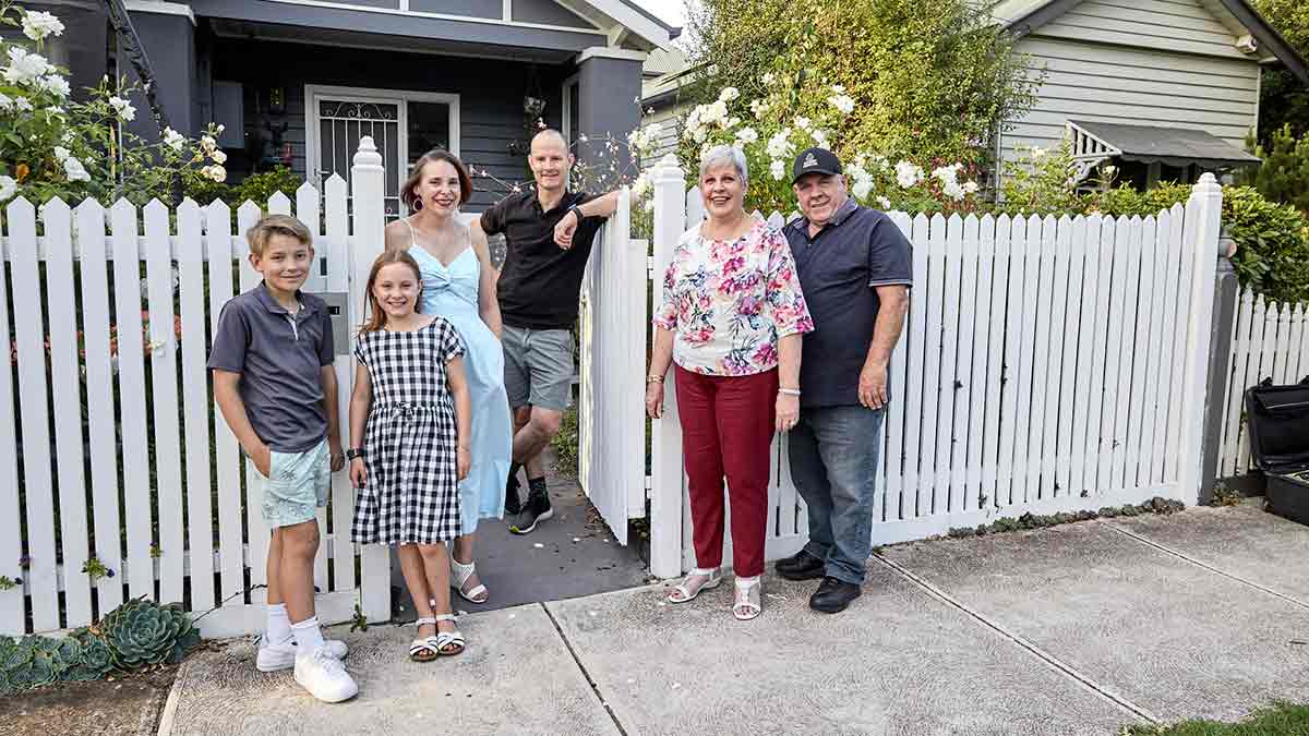 Two neighbours and their families in front of a house