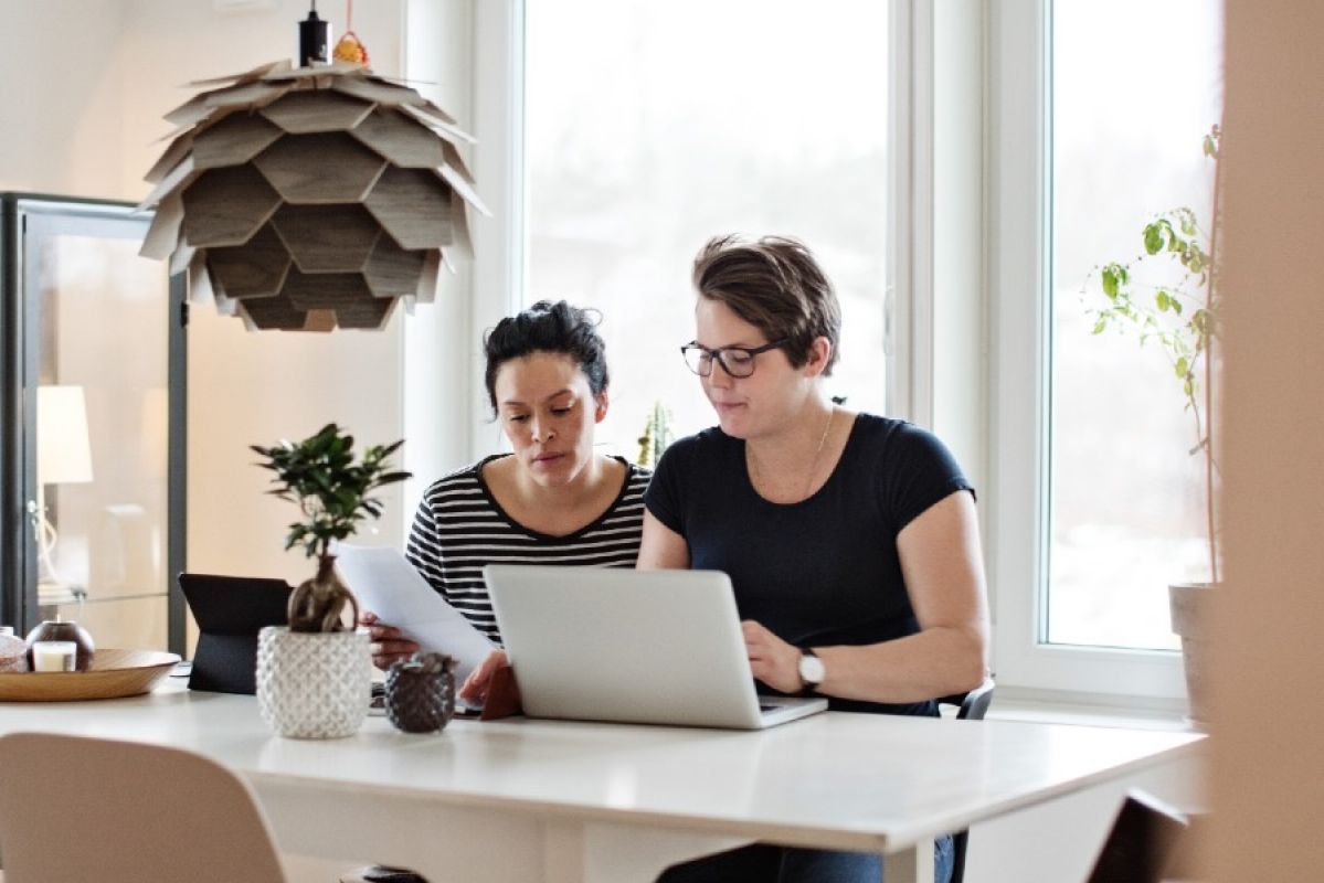 two women looking at laptop together