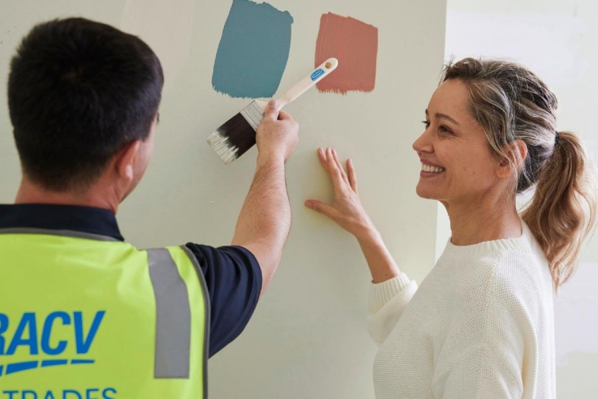 Woman and man deciding between colours for a wall