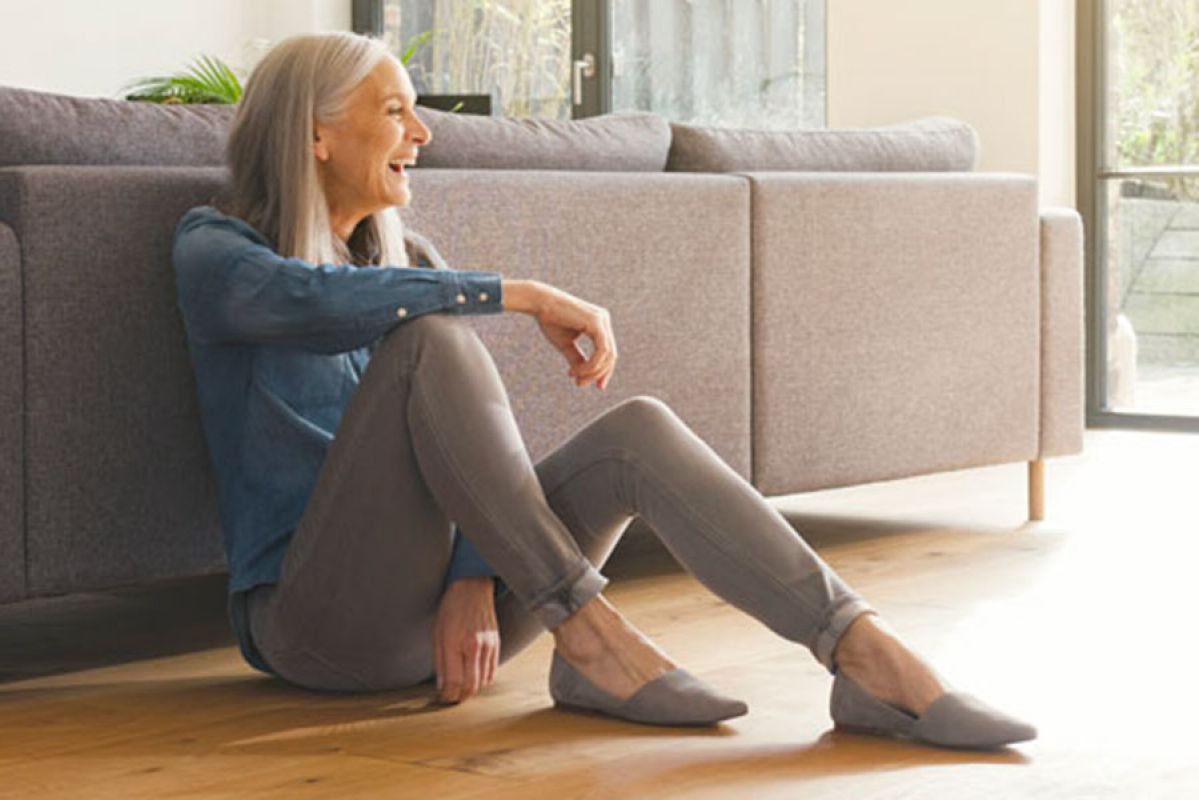 Grandma and grandkids playing inside on hardwood floors