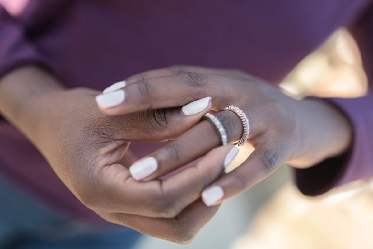 woman's hands with diamond rings