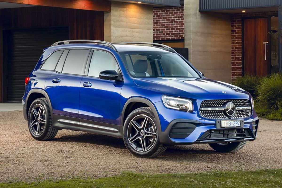 Front side view of a blue Mercedes-Benz GLB250 2020 car parked in a driveway