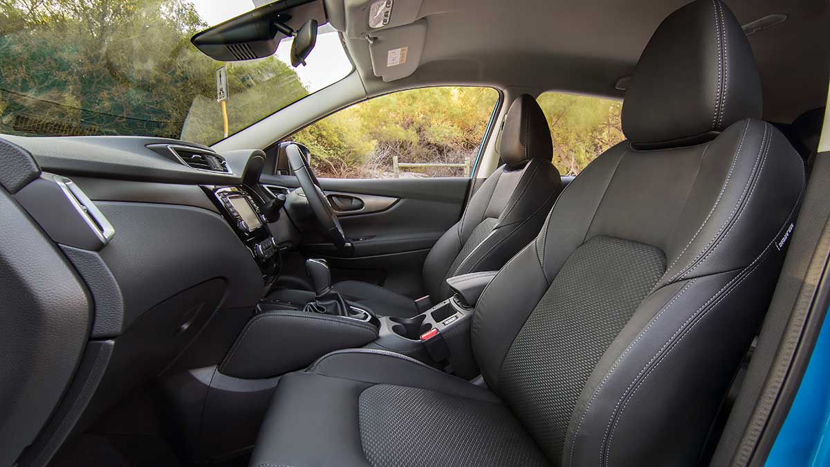 The Nissan Qashqai's interior features: smart looking heated front seats made out of cloth and leather