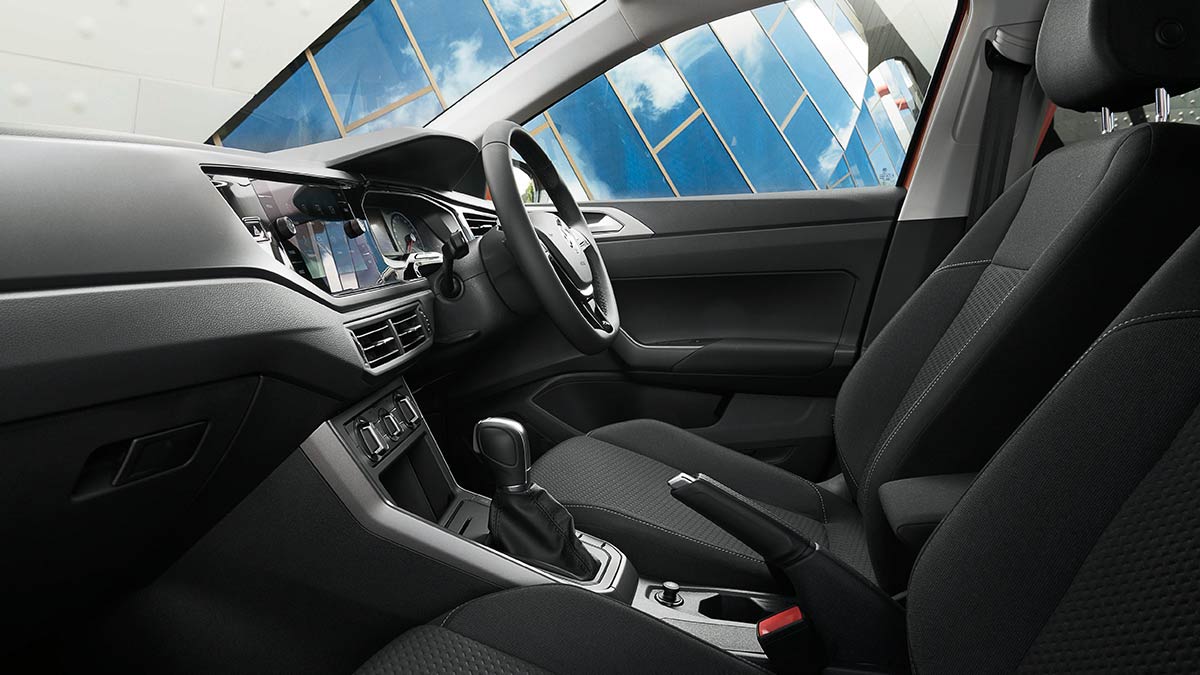 Dark grey interior of the Volkswagen Polo 2018 showing the front seats, dashboard and steering wheel