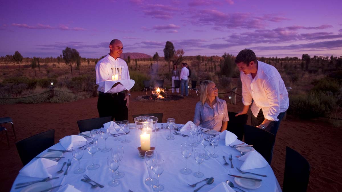 People setting up table in desert