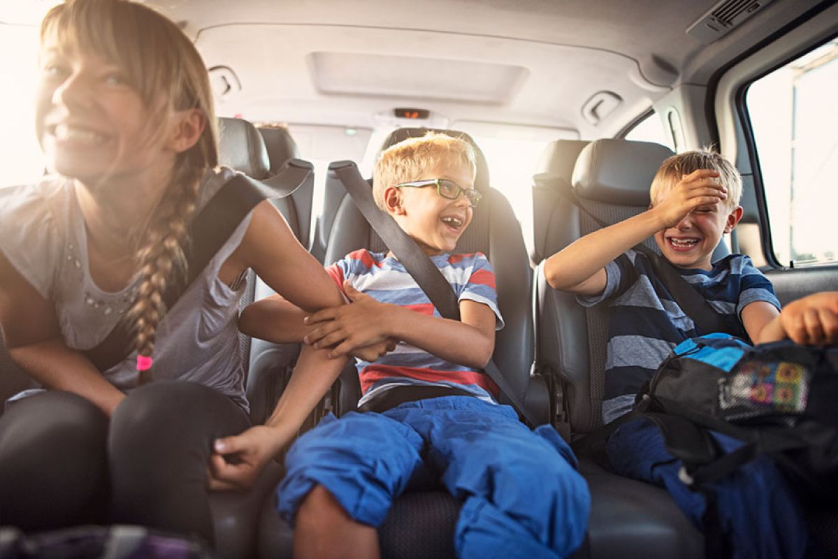 kids laughing in the backseat of a car