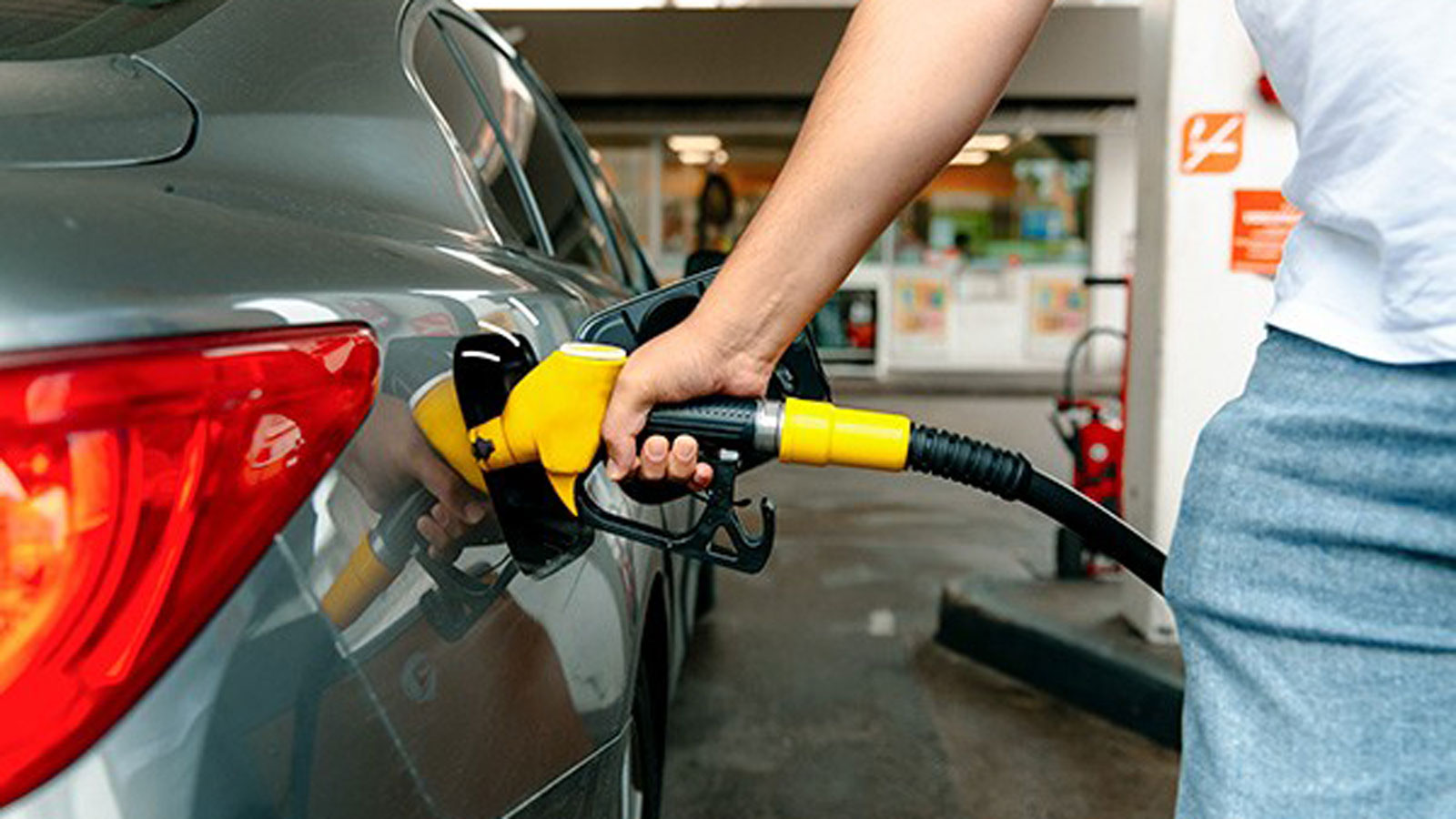 A person filling  their car up with petrol.
