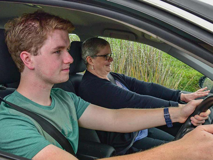 Young man in the drivers seat with an instructor as the passenger.
