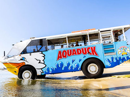 Aquaduck vehicle entering water from the beach.