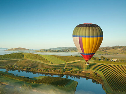 Hot air balloon flying over the Yarra Valley wine region.