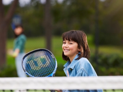 A girl playing tennis at the Healesville Country Club.