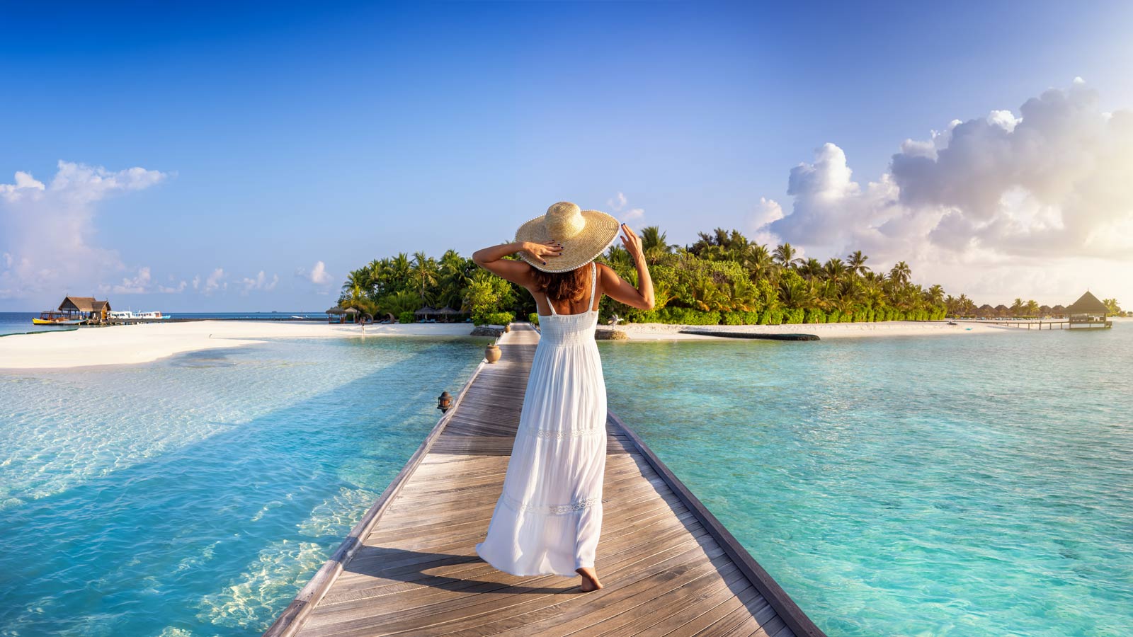 Woman walking down a pier on the beach