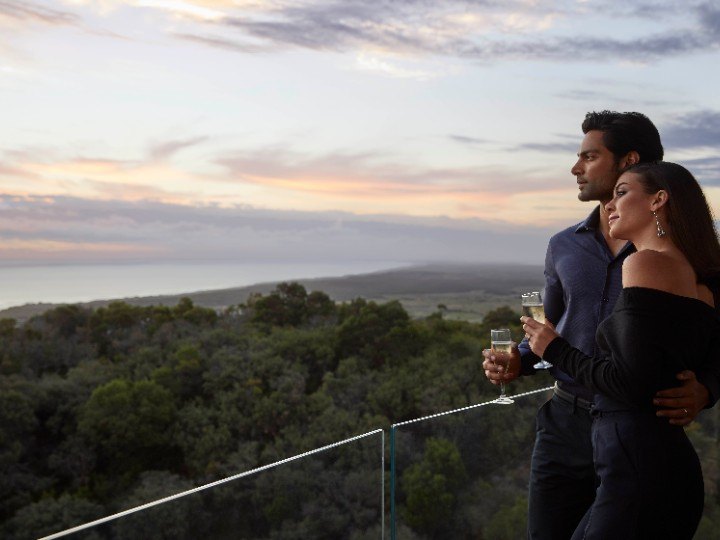Couple enjoying the view from their room's balcony at Cape Schanck.
