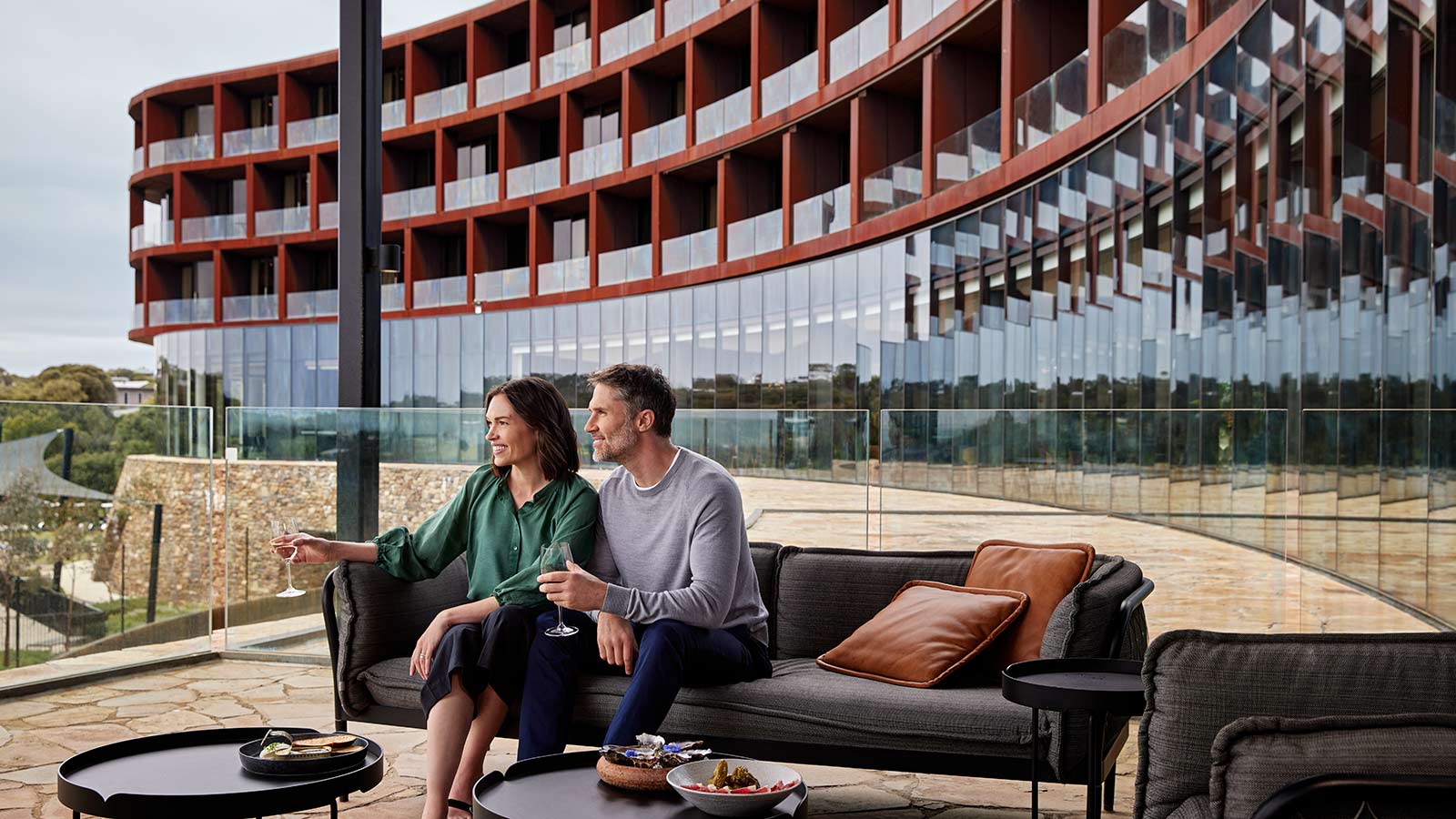 Couple sitting on a couch at RACV Cape Schanck's Cape Bar and Terrace.