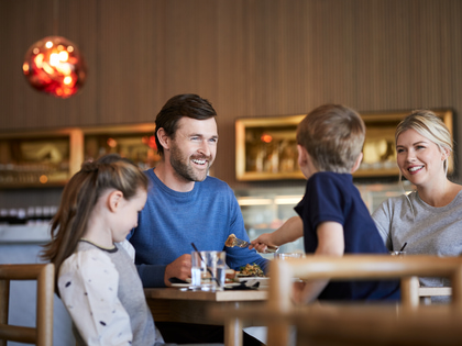 Family dining at a table in RACV's Mantellina restaurant.