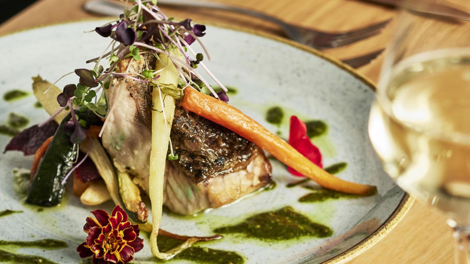 Meal at RACV Goldfields Resort's Three Founders restaurant, featuring grilled fish and roast vegetables.