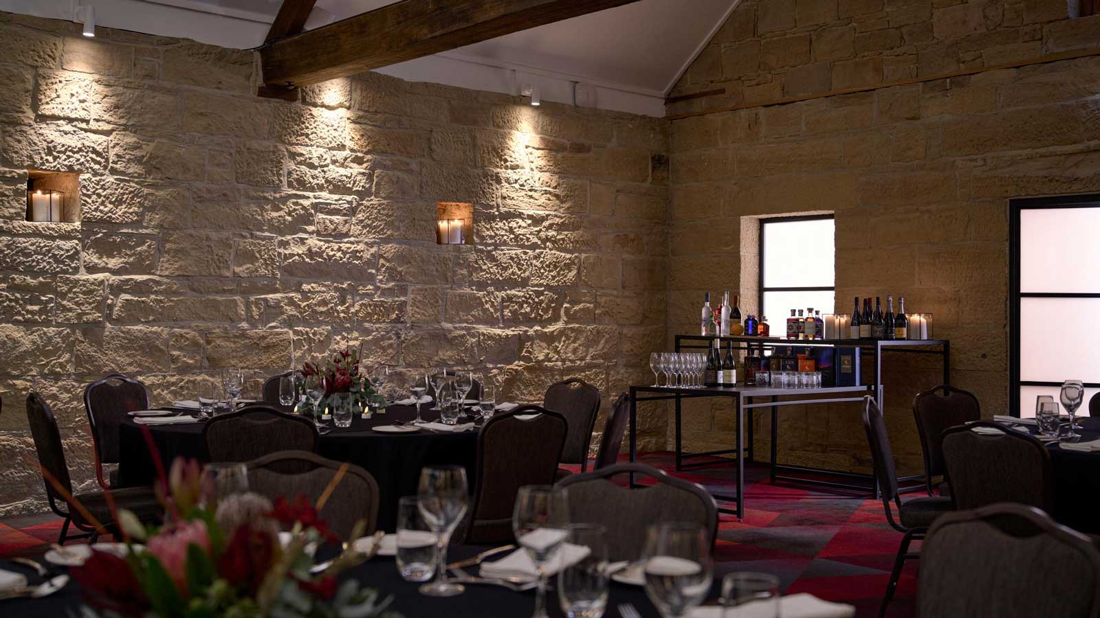 The Stables set up for dinner service with a bar.