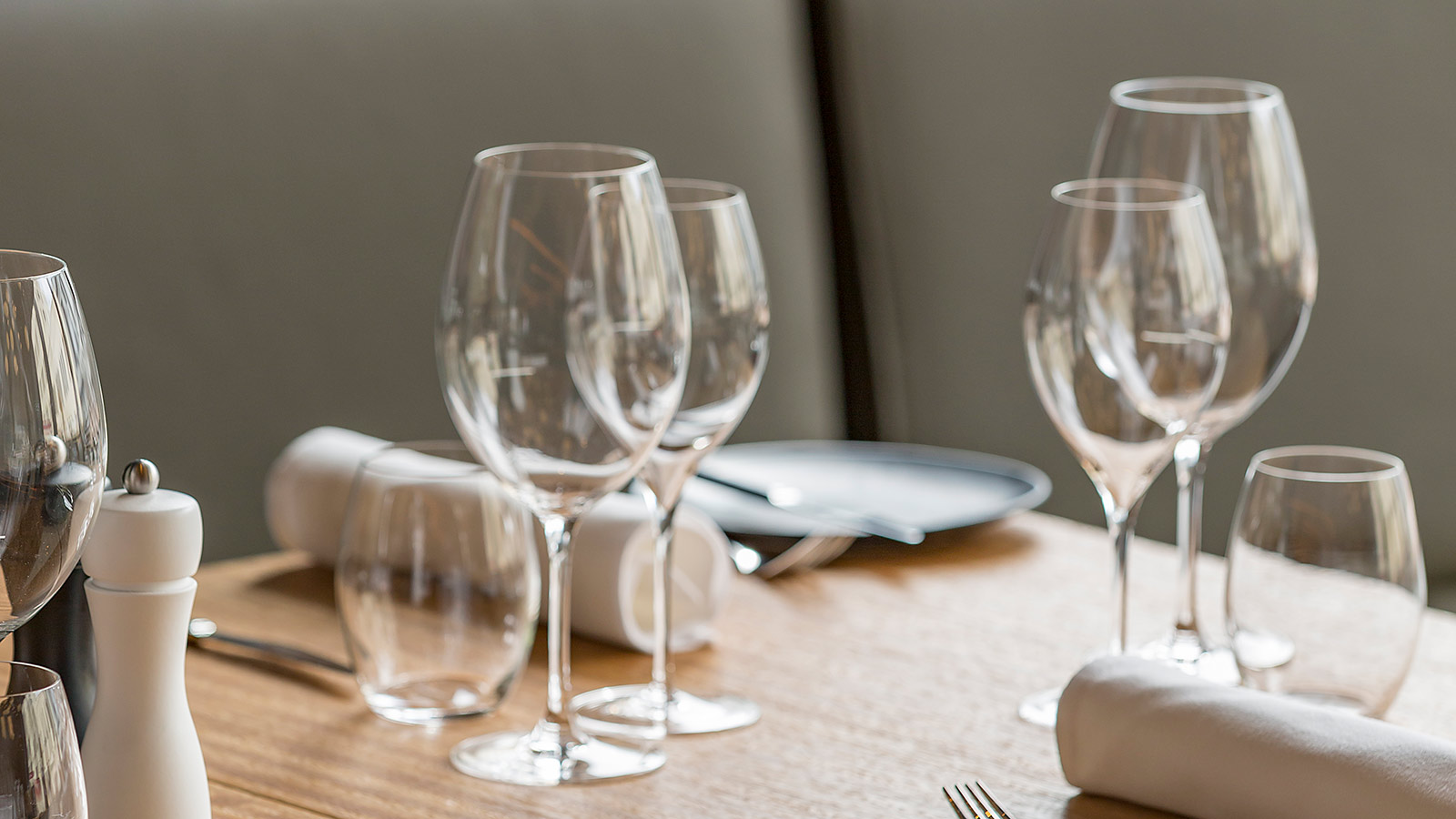 A table at RACV Hobart Hotel's Charcoal restaurant, set with wine glasses, plates, napkins and cutlery.