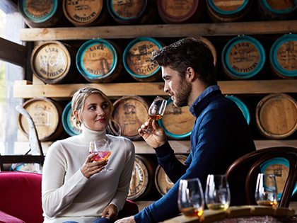 Couple doing a whisky tasting at a bar in Hobart.