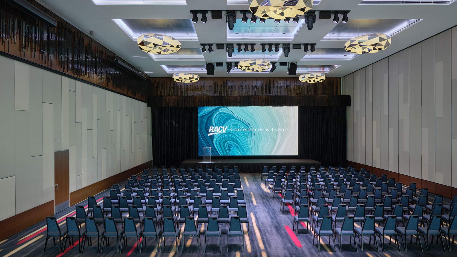 Royal Benowa Ballroom at RACV Royal Pines Resort, with a partition separating it into a smaller section that's set up theatre style.