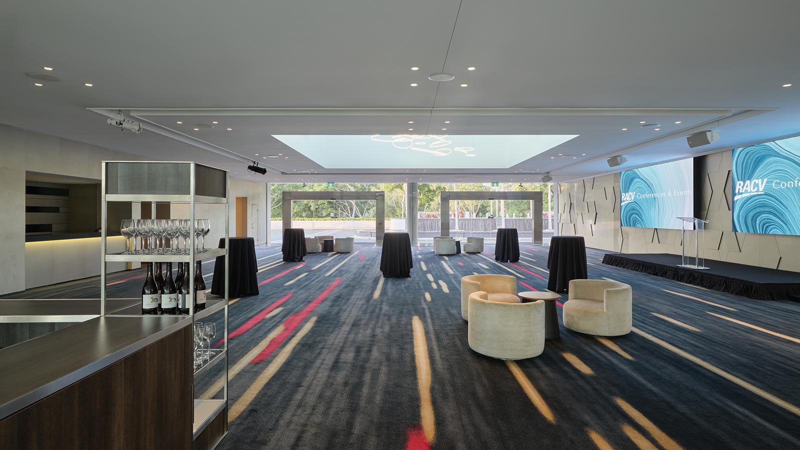 Royal Poinciana's pre function room at RACV Royal Pines Resort, featuring couches and a bar.