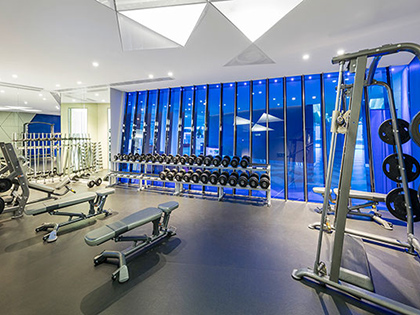 Fitness centre at RACV Royal Pines Resort, featuring weights and gym equipment.