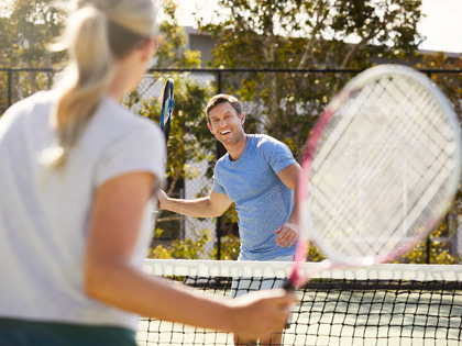 Couple playing tennis together