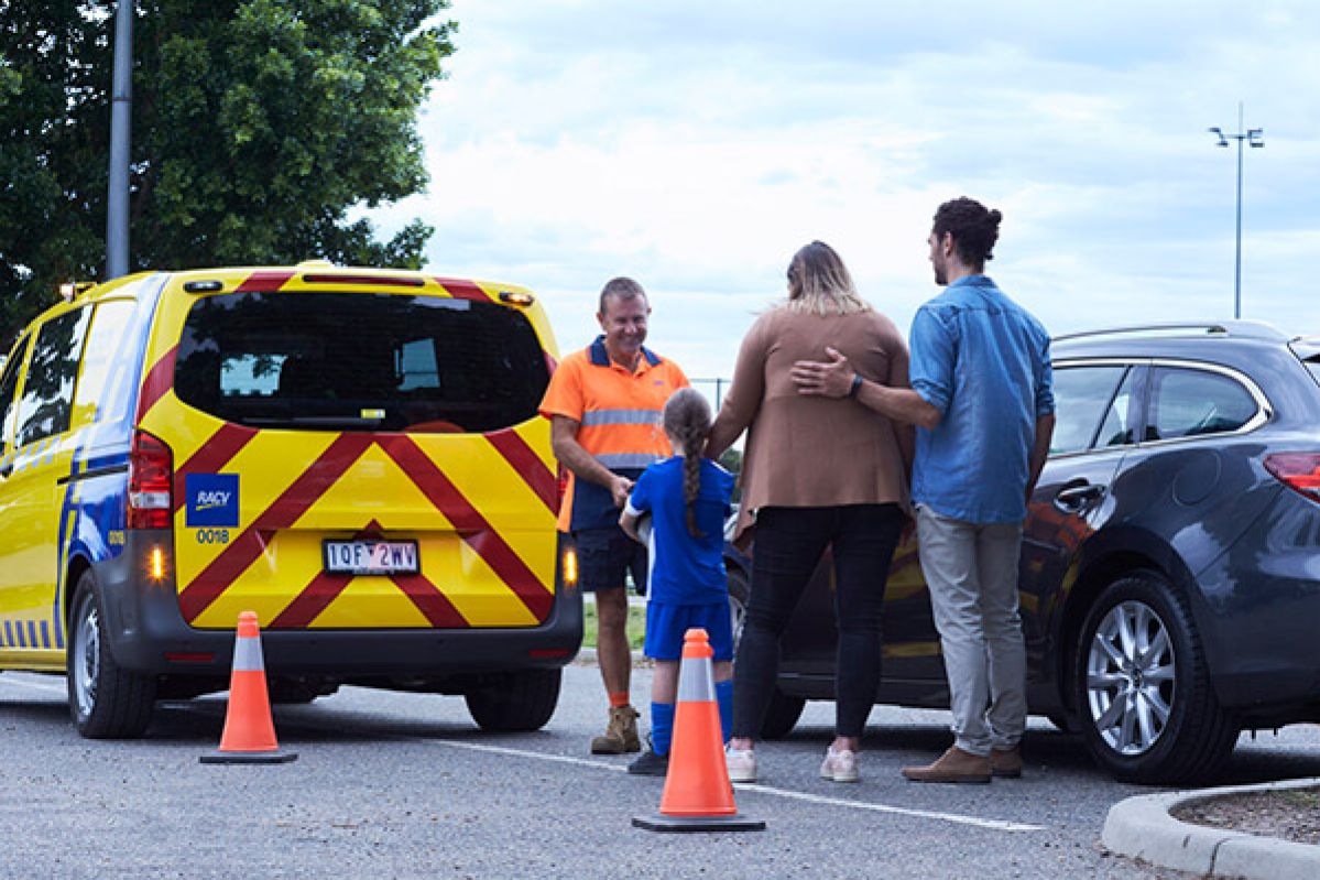 Emergency Roadside Assistance vehicle assisting family