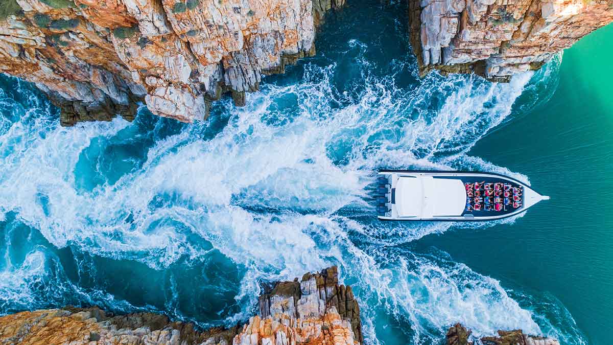 Boat passing through a river between two mountains