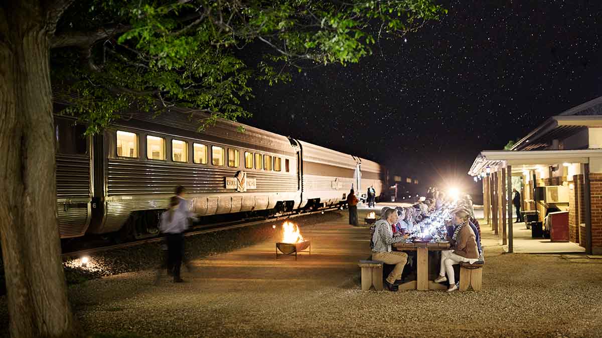 Train passengers enjoying a meal next to a train