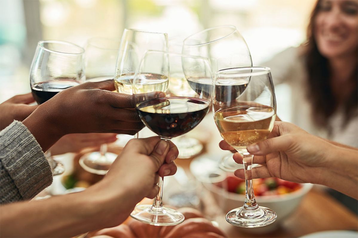 Friends enjoying red and white wine with food