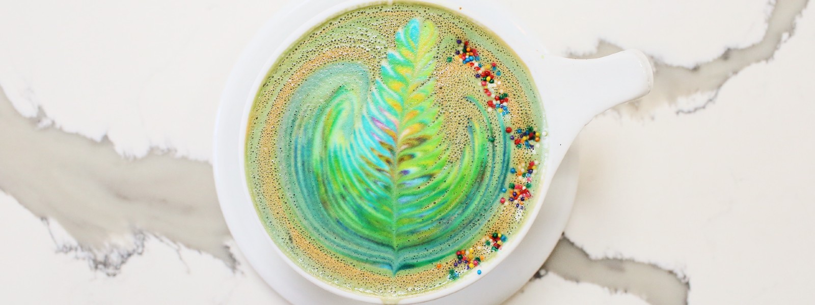 rainbow latte art on top of a coffee