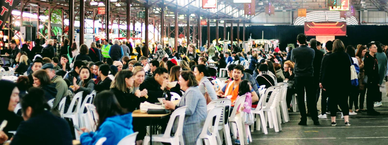 rows of tables of people at Melbourne night markets