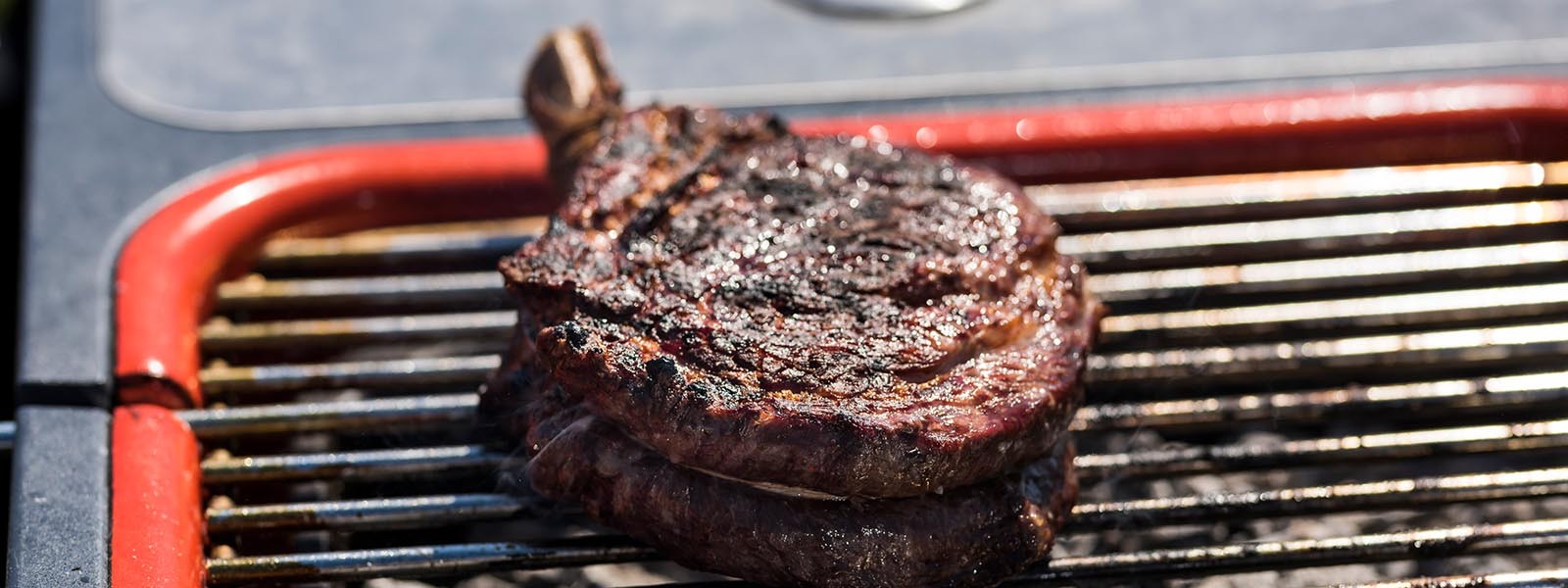 cooked ribeye steak on outdoor grill