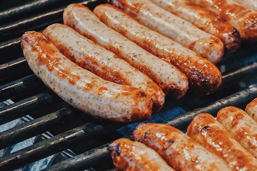 The Trick For The Juiciest Grilled Sausages Is Poaching Them First