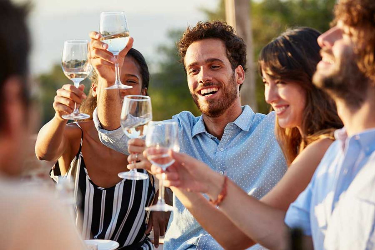 People enjoying white wine outside