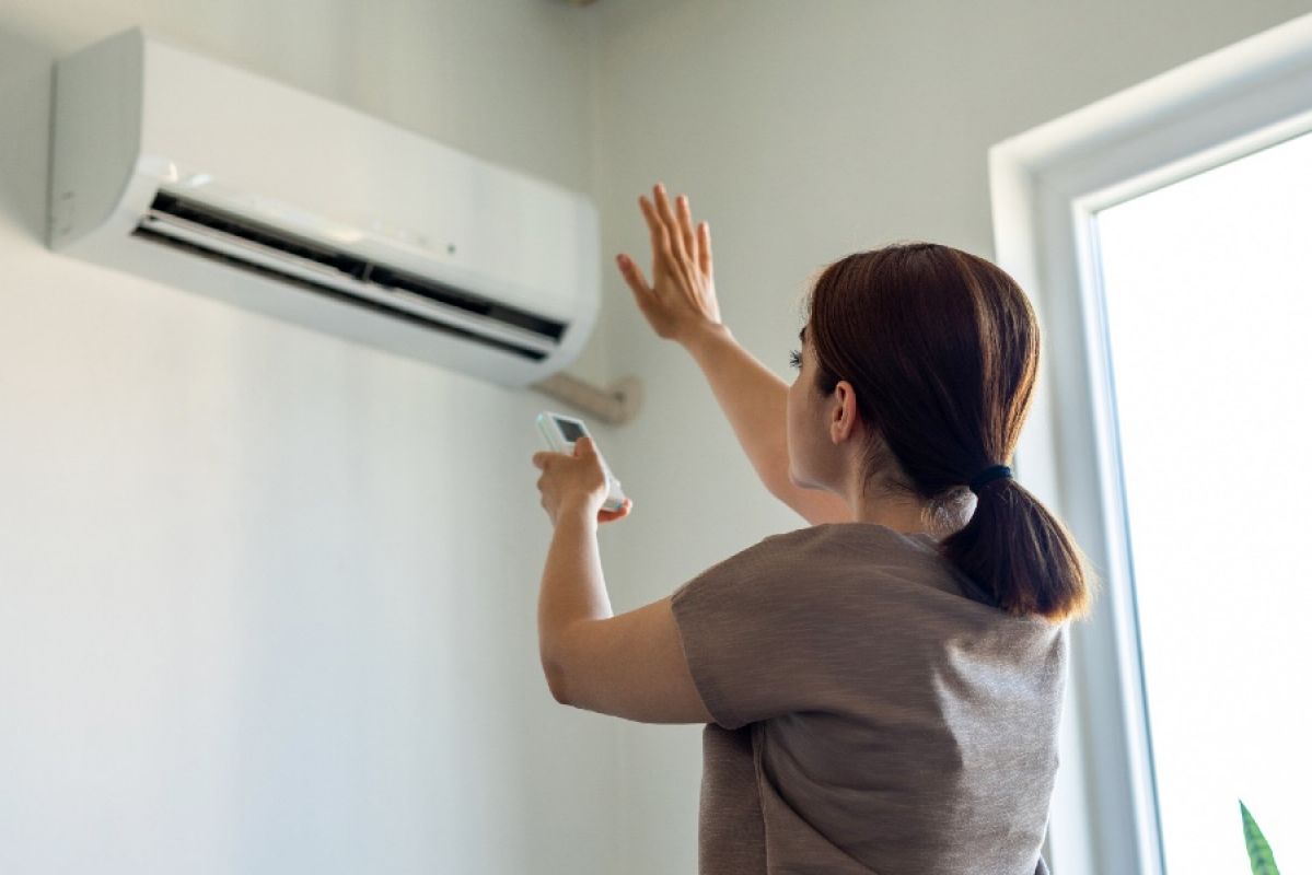 woman in front of air conditioner