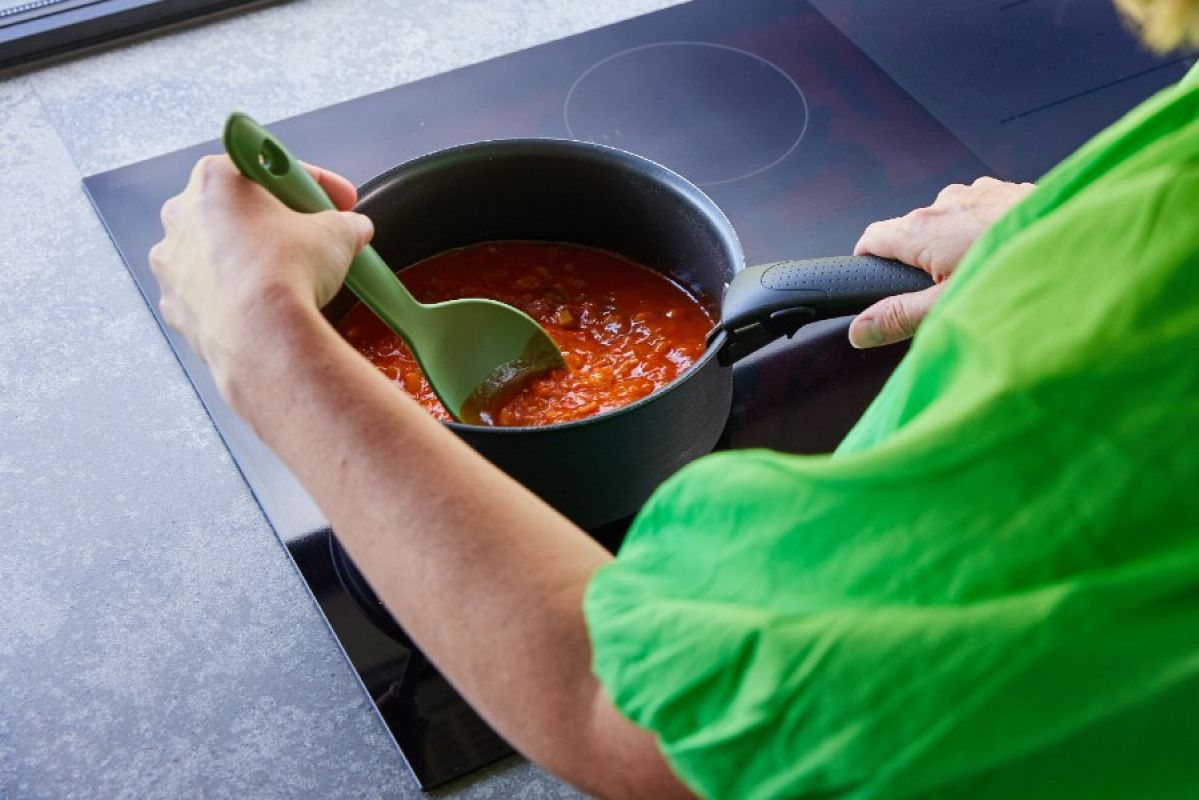 woman cooking on an induction cooktop
