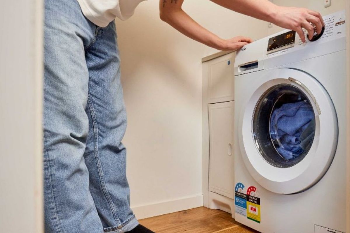 man loading a washing machine