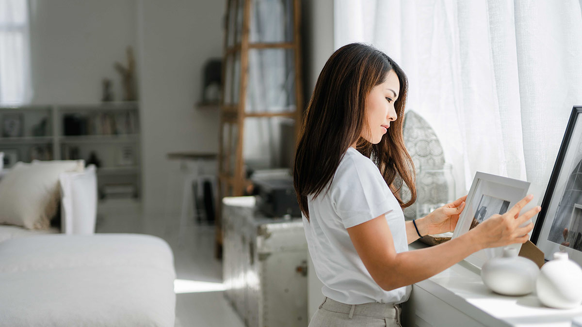 Woman looking at photo frames