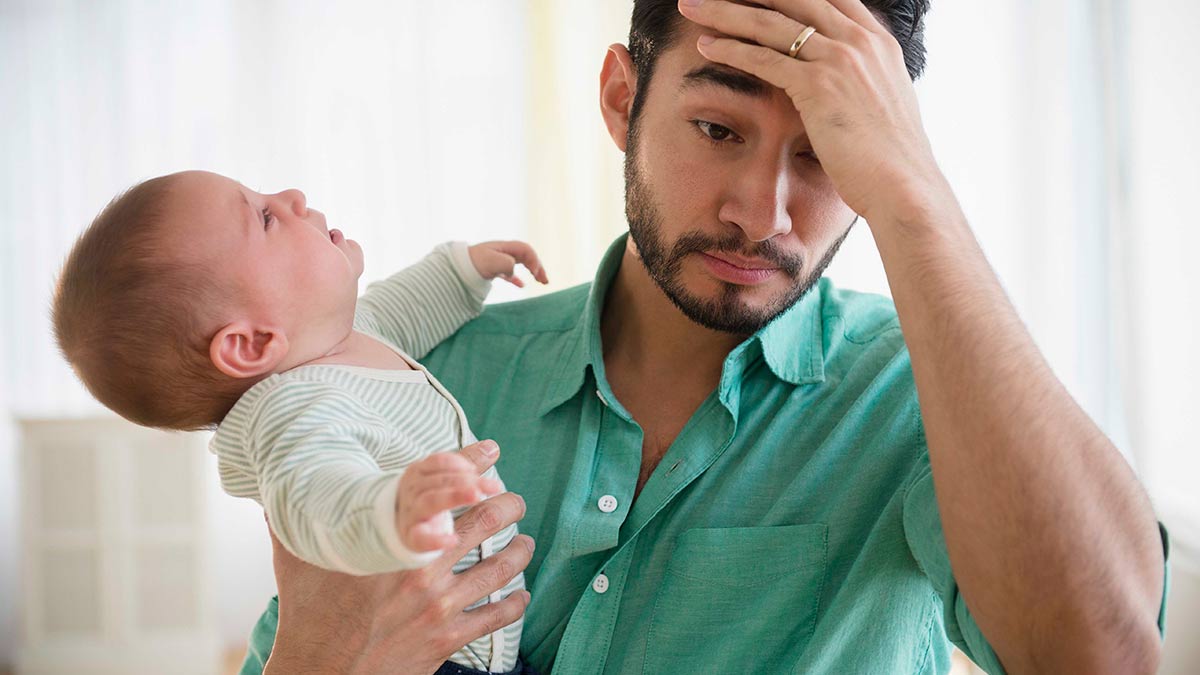 Man holding crying baby