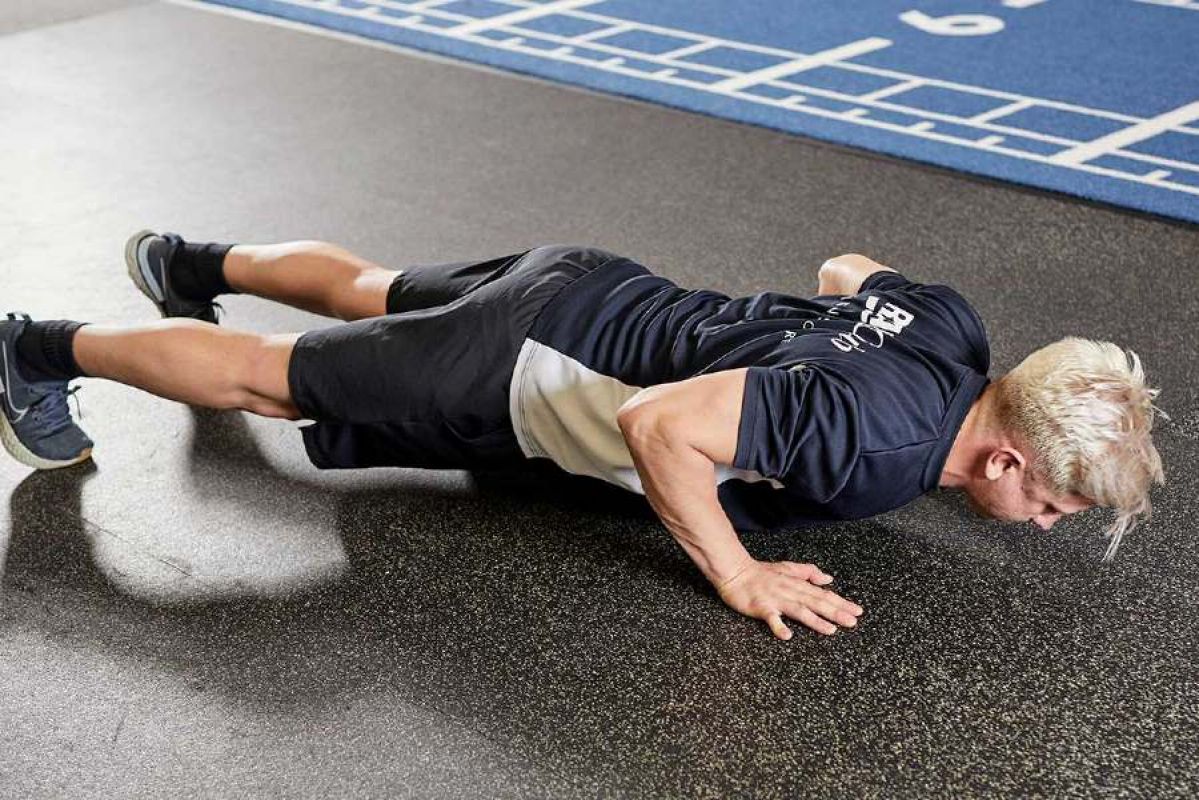 Personal trainer doing a push up