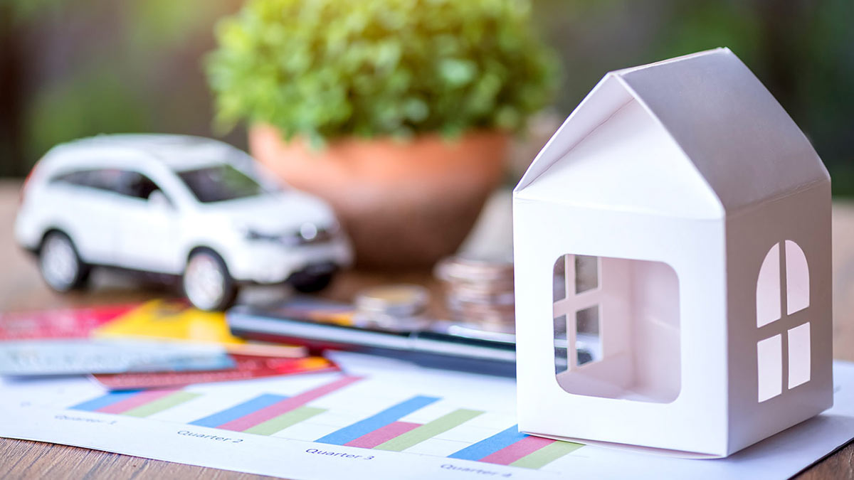 Photo of paper house with car in the background