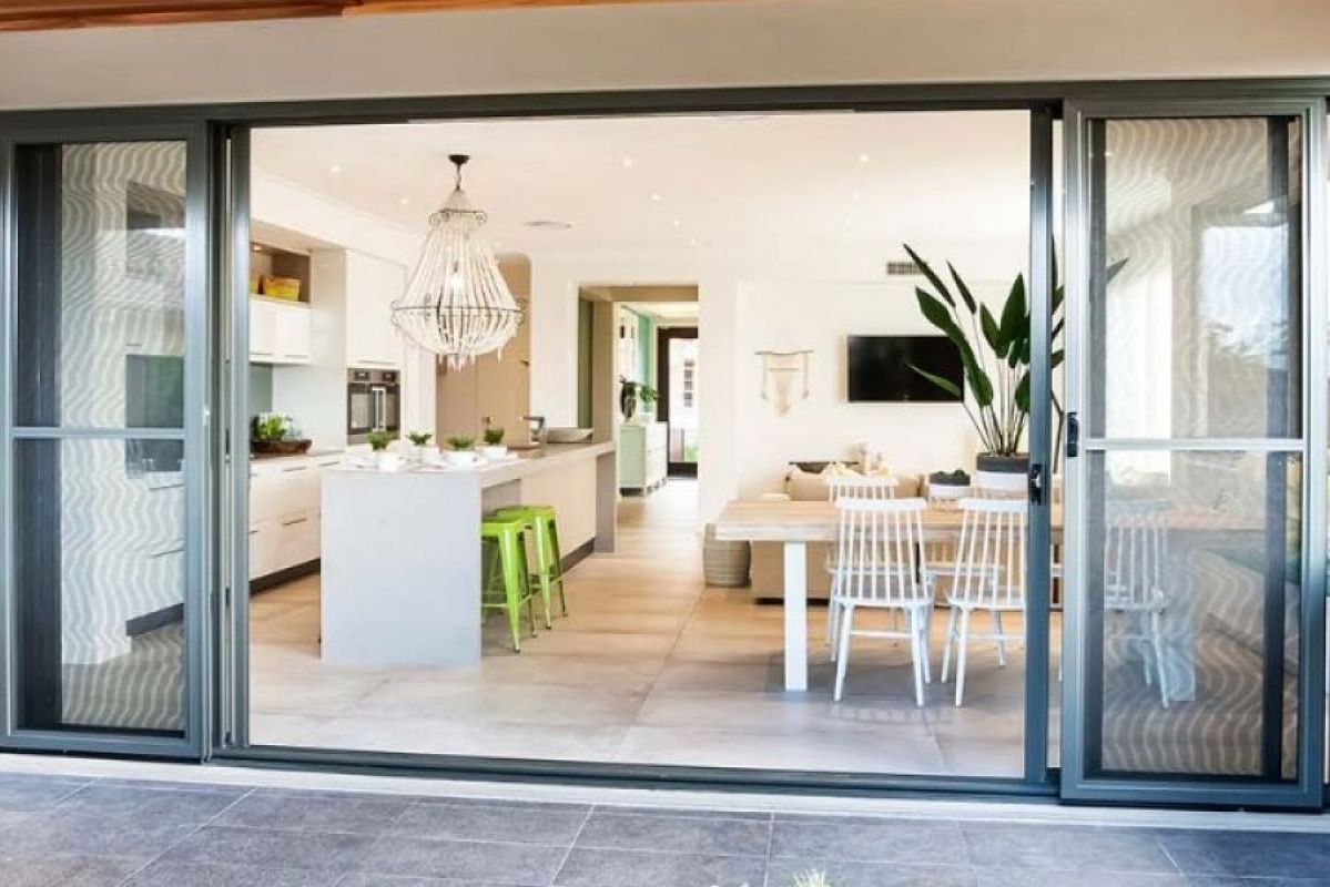 outdoor view of modern kitchen with open sliding doors