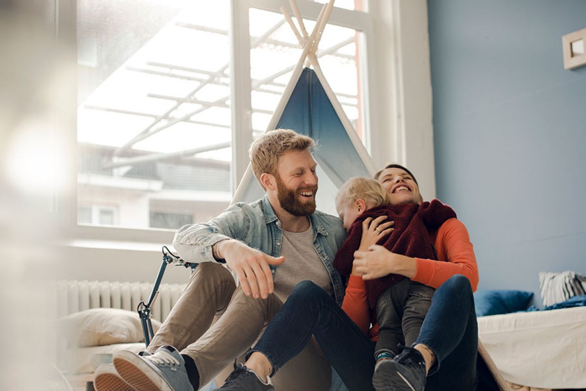 Family smiling in their home